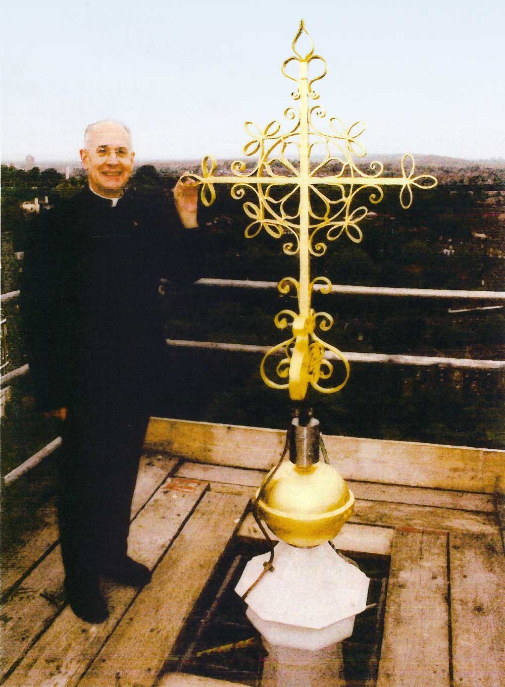 Fr John Lavery re-erects the cross on top of the spire 2007